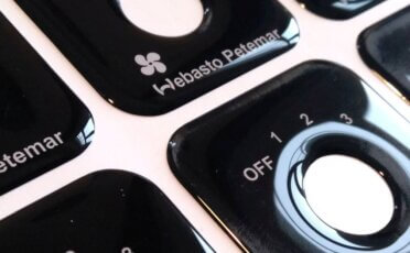 Custom-made black domed stickers with special shape