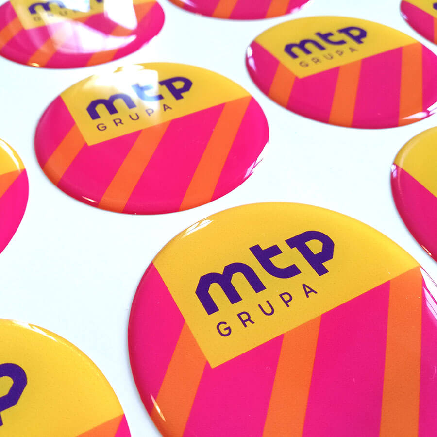 Domed label with the MTP Group logo